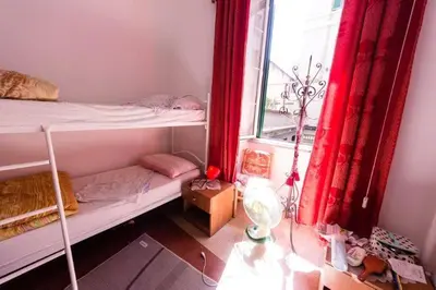 a dorm room with a bunk bed and a window at SUNSHINE HOSTEL in Rome
