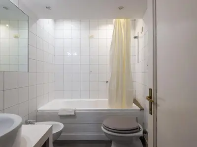 a bathroom with a tub and a toilet and a sink at Apartment Antico Balcone by Interhome in Rome