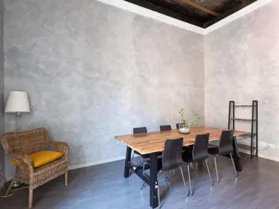 a dining room with a wooden table and chairs at Apartment Antico Balcone by Interhome in Rome
