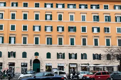 a large building with cars parked in front of it at A Casa Lamperini 59 in Rome