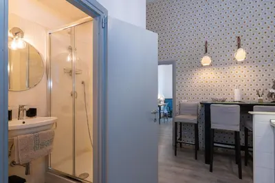 a bathroom with a shower and a sink and a table at A Casa Lamperini 59 in Rome
