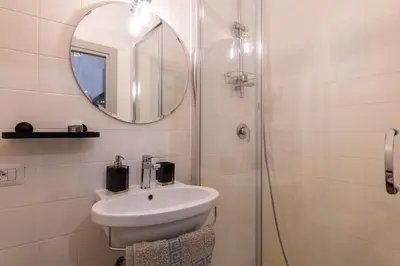 a bathroom with a sink and a mirror at A Casa Lamperini 59 in Rome
