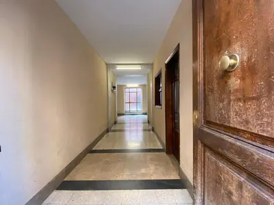 an empty hallway with a wooden door and a hallway at Colosseo Apartment 23 in Rome