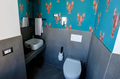 a bathroom with a white toilet and a sink at Ottaviano Smart Rooms in Rome