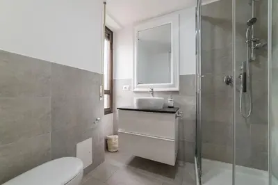 a bathroom with a sink and a shower at GuestHost - Sant'Angelo Modern Apartment in Rome