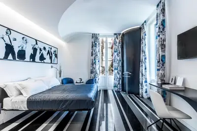 a bedroom with a bed and a tv on a wall at V-Accommodation IV Fontane in Rome