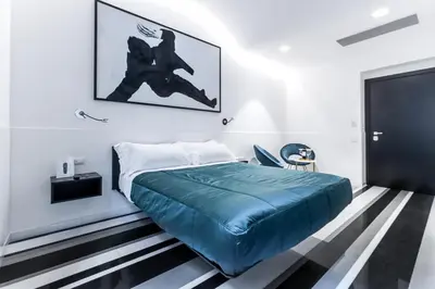 a bedroom with a bed with a blue blanket at V-Accommodation IV Fontane in Rome