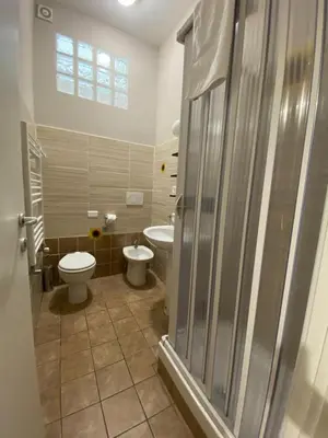 a bathroom with a toilet and a sink at èROMA - RE DI ROMA Apartment in Rome