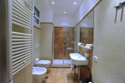 a bathroom with two sinks and a shower at RELAIS CAVOUR 133 in Rome