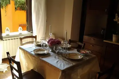 a dining room table with a table cloth on it at La Finestra su Trastevere - Appartamento 100 mq Centrale, Luminoso, Spazioso in Rome