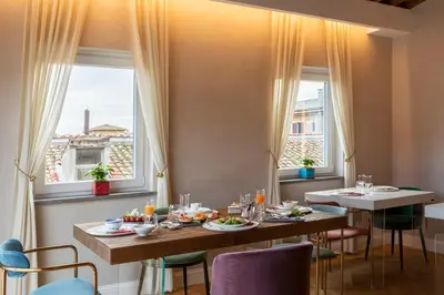 a dining room with a table with food on it at Poēsis Experience Hotel in Rome