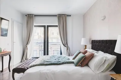 a bedroom with a large bed with a window at La Suite al Vaticano in Rome