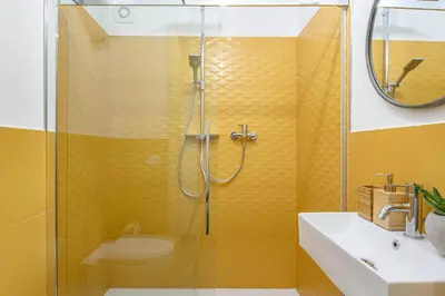 a bathroom with a shower with a toilet and a sink at Industrial-Style Apartment Next To Vatican Metro in Rome