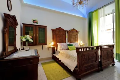 a bedroom with a large wooden bed and a window at GEMMA DOMUS in Rome