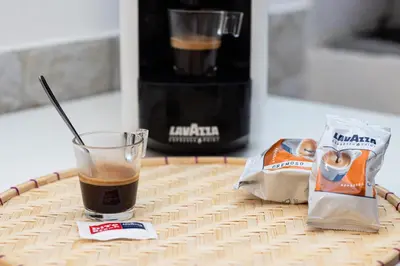 a glass of coffee and a bag of chips on a table at Deluxe Suite Welness in Rome
