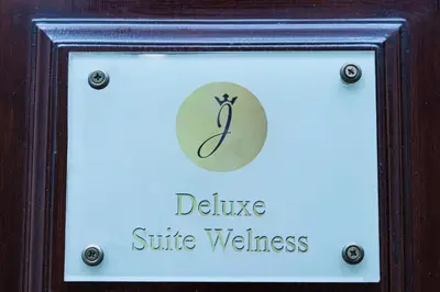 a sign on a door with the words divine strike wellness at Deluxe Suite Welness in Rome