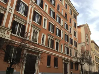 a large building with a clock on the side of it at LE FATE STUDIO a San Pietro in Rome