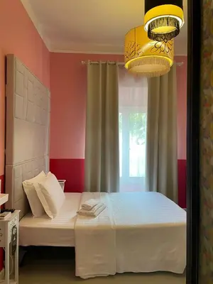 a bedroom with a bed and a chandelier at Stefano House Vaticano Roma in Rome