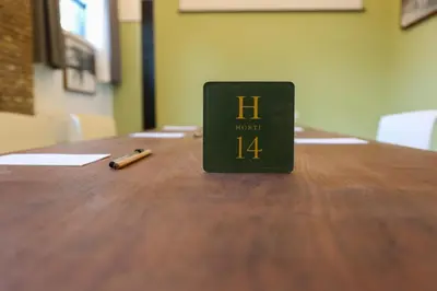 a book sitting on top of a wooden table with a pen at Old Town Home Trastevere in Rome
