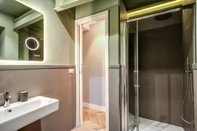 a bathroom with a sink and a shower at Trevi Fountain Superior 3 bdr apartment in Rome