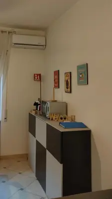 a kitchen with a counter with a microwave at Cosy Apartment 5 minutes from St Peter in Rome