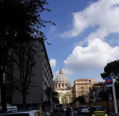 a view of a building with a dome in the background at Cosy Apartment 5 minutes from St Peter in Rome