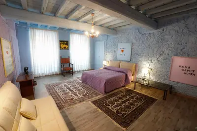a bedroom with a bed and a couch in a room at Rome old town luxury loft in Rome