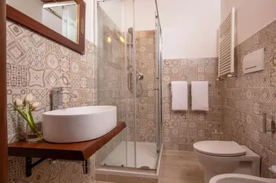 a bathroom with a sink and a shower and a toilet at Residenza Nobile Laurina in Rome