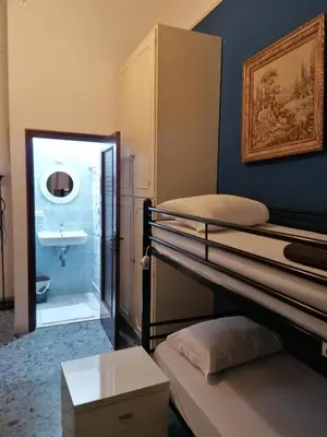 a room with two bunk beds and a bathroom at Dream Destination Rome in Rome