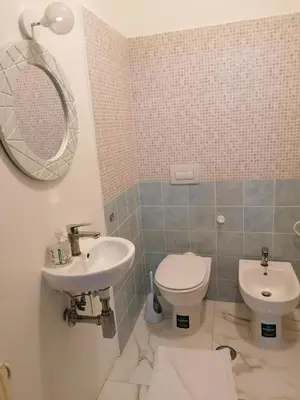 a bathroom with a sink and a toilet and a mirror at Dream Destination Rome in Rome