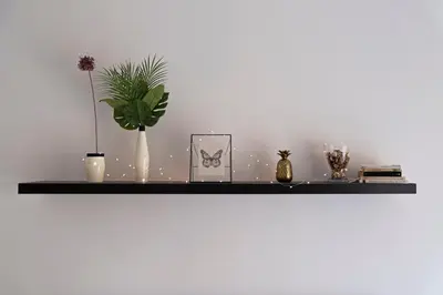 a black shelf with plants and vases on it at The Good Place B&B in Rome