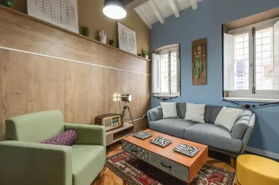 a living room with two couches and a table at Rome As You Feel - Torre Design Apartment in Rome