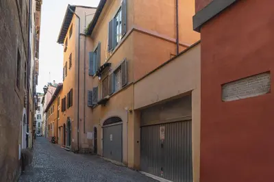 an alley with two garage doors in a city at GuestHost - Charming Loft Navona in Rome