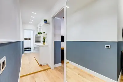 a kitchen and living room with a blue wall at Glamour Studio - Spanish Steps in Rome