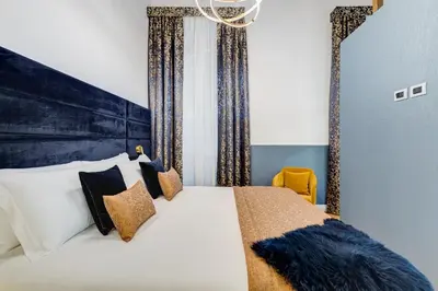 a bedroom with a large bed with a large headboard at Glamour Studio - Spanish Steps in Rome