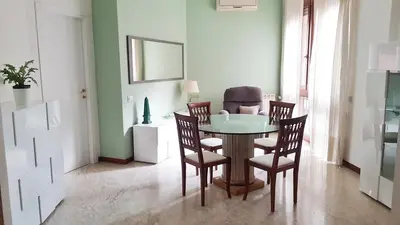 a dining room with a table and four chairs at STEFY ROME APARTMENT in Rome
