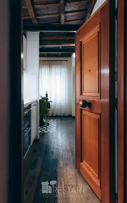 an open door to a room with a table at Restart Accommodations Rome in Rome