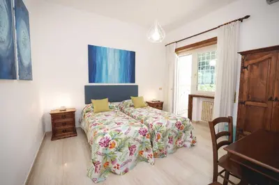 a bedroom with a bed with a colorful bedspread at Le Tare B&B in Rome