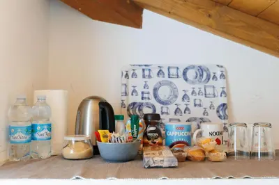a kitchen counter with some food and bottles of water at Casa Caudì in Rome