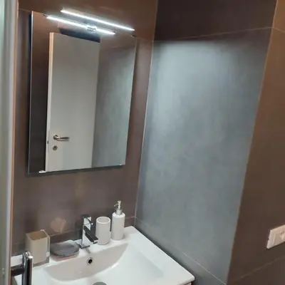 a bathroom with a white sink and a mirror at Casa Caudì in Rome