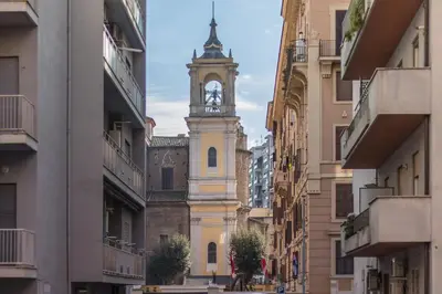 a building with a clock tower in the middle of a street at Vaticano San Pietro Apartment in Rome