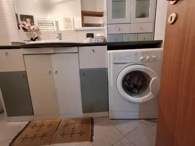 a kitchen with a washing machine and a sink at Elegante appartamento immerso nei Fori Imperiali in Rome