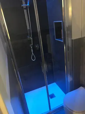 a shower with a glass door and a toilet at Room 76 in Rome