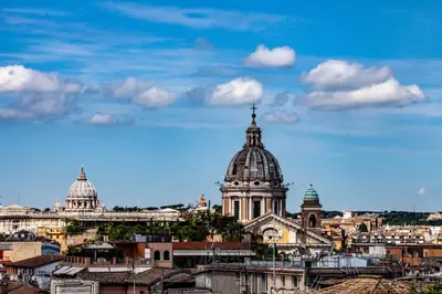 a view of a city with a cathedral and buildings at Apartment Spanish Steps with panoramic roof-terrace in Rome