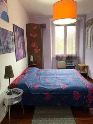 a bedroom with a bed with a blue comforter at BREAD & BUTTER in Rome