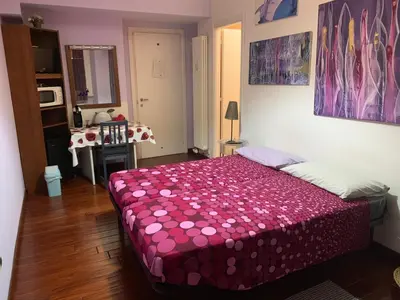 a bedroom with a bed with a pink blanket at BREAD & BUTTER in Rome