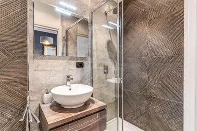 a bathroom with a sink and a glass shower at Stasera a casa da M.E. in Rome