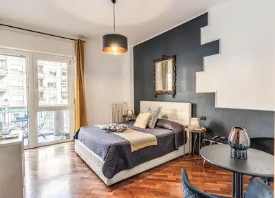 a bedroom with a bed and a table at Stasera a casa da M.E. in Rome