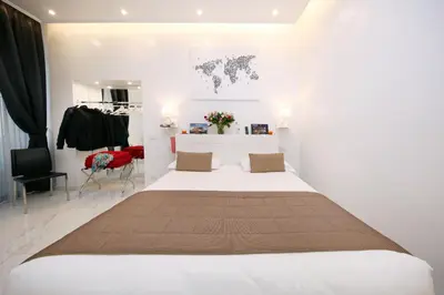 a bedroom with a large bed in a room at La Maisonnette Tritone Trevi Apartment Rome in Rome