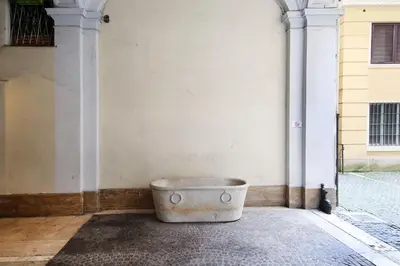a bucket sitting in the corner of a building at La Maisonnette Tritone Trevi Apartment Rome in Rome